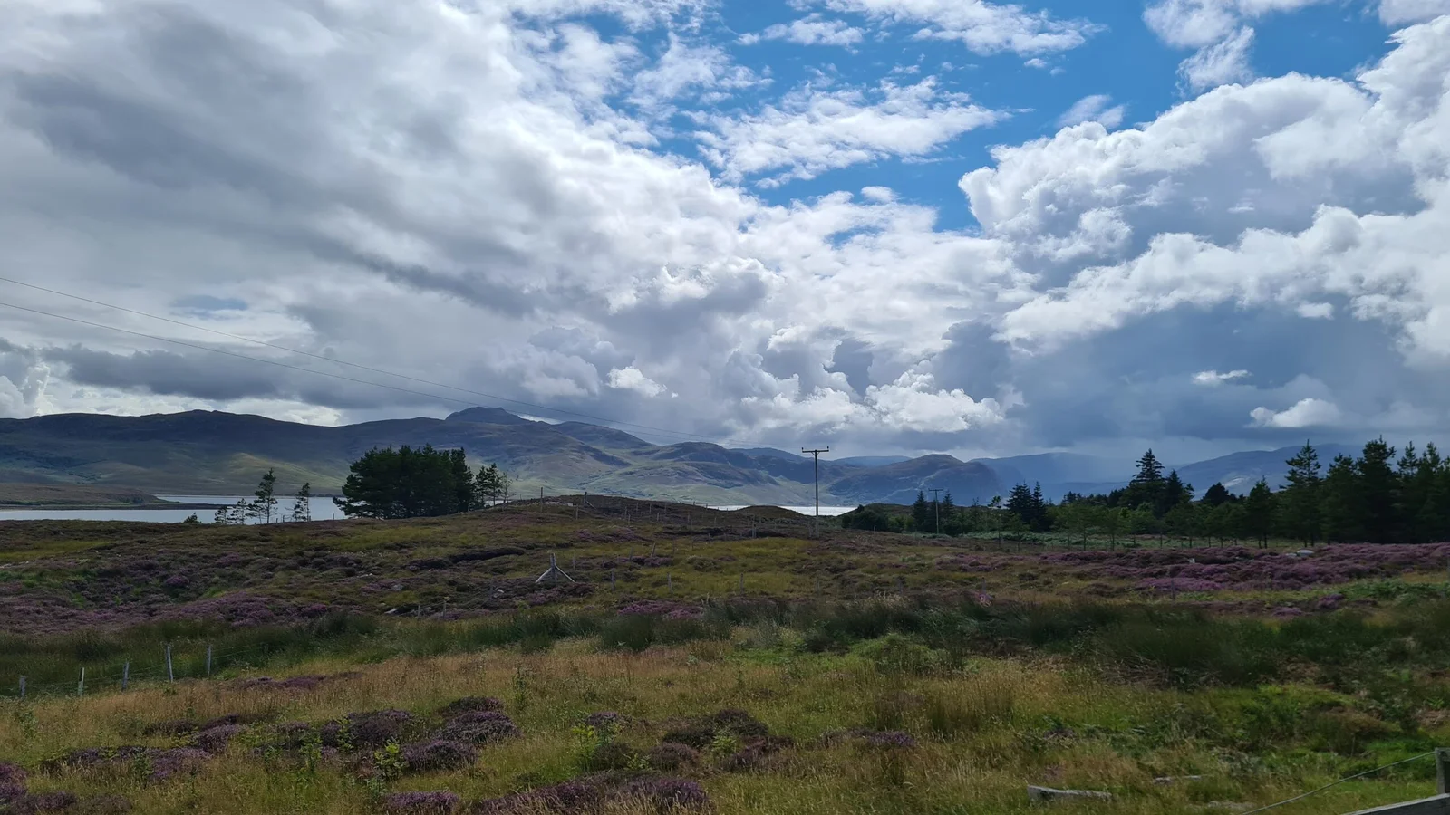 An image of a landscape with rolling mountains behind